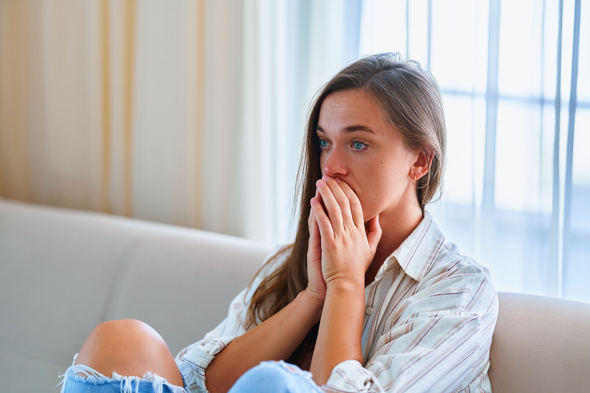 Sad upset depressed crying melancholic woman sitting alone at home